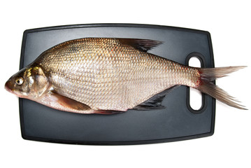 Fresh fish bream on a cutting board on a white background