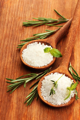 salt in spoons with fresh basil, thyme and rosemary isolated