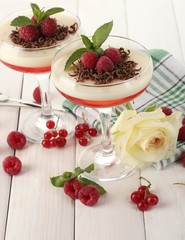 fruit jelly with berries in glasses on wooden table