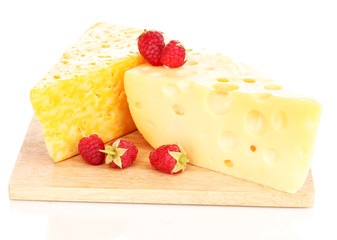 tasty cheese and berries on wooden board isolated on white