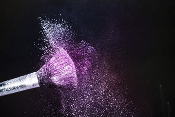 Cosmetic brush with purple cosmetic powder spreading for makeup artist and graphic design in black...