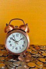 alarm clock and coins concept of time and saving