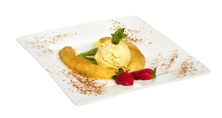 Dessert of banana, ice-cream, caramel, strawberry and mint