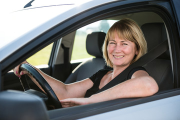 Portrait of senior woman in car