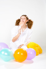 girl with a pajamas with multi-colored balloons