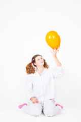 girl with a pajamas with multi-colored balloons