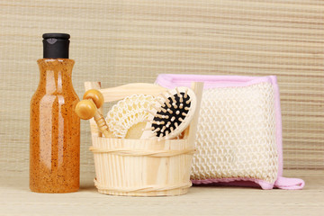 Bathroom set with scrub on bamboo background