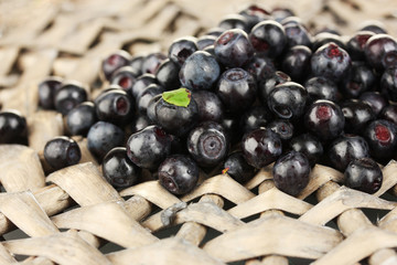 Fresh blueberries on wicker mat close-up