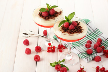 fruit jelly with berries in glasses on wooden table