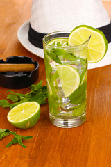 Mojito and a hat on a wooden background