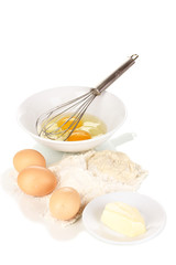 Eggs, flour and butter isolated on white