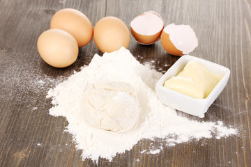 Eggs, flour and butter close-up on wooden table