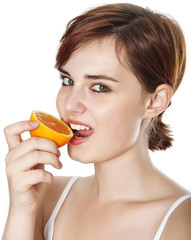 young woman eating an orange