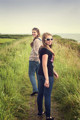 Two pretty teenagers walking on a dike