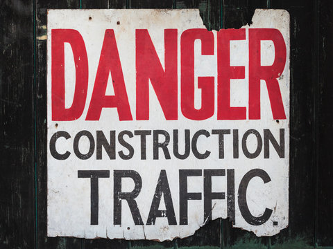 Old sign with text danger construction traffic