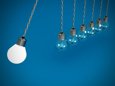 concept teamwork pendulum from bulbs on blue background