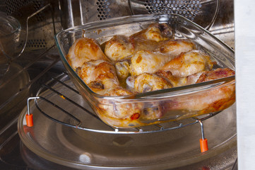 Chicken legs on a glass dish in the convection oven