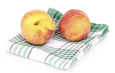 ripe peaches on napkin isolated on white.
