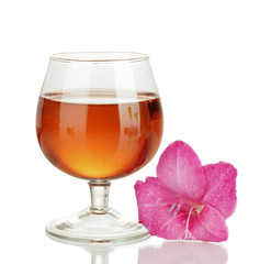 glass with cocktail and gladiolus bud isolated on white