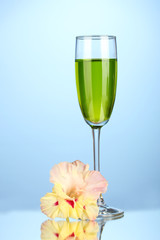glass with cocktail and gladiolus bud