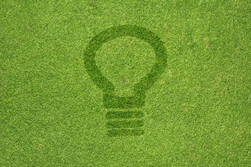 Bulb light icon on green grass texture and  background