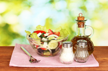 tasty greek salad on bright green background