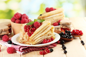 pancakes with berries, jam and honey