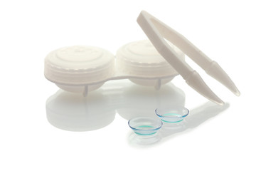 contact lenses, containers and tweezers isolated on white
