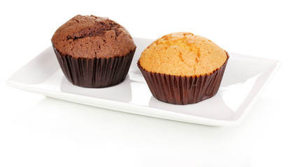 Fresh muffins on plate isolated on white