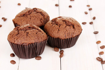 Fresh muffins on wooden background