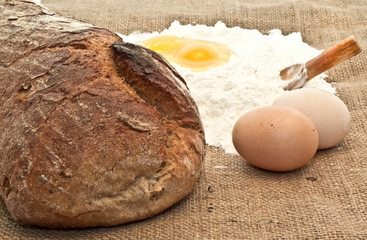 Fototapeta na wymiar Fresh bread Eggs and flour on the canvas