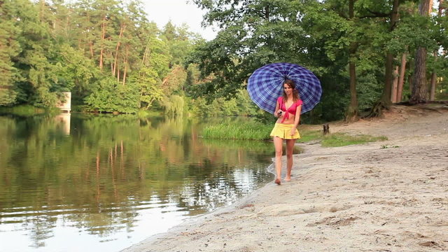 girl with an umbrella near the lake