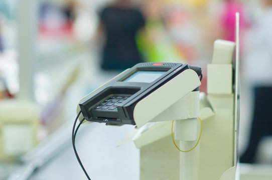 Credit card reader terminal on cash-desk in supermarket