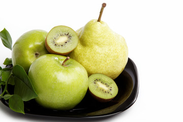 Fresh fruit. Apples and pears on a plate isolated over white bac