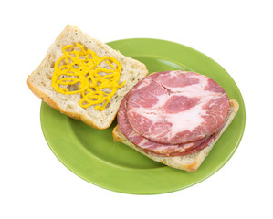 Open faced capicolla sandwich with mustard