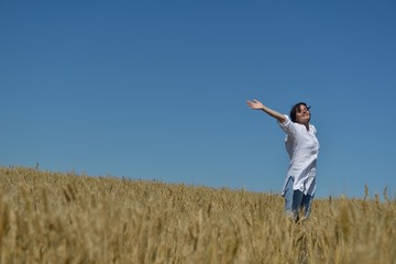 Fototapeta premium young woman in wheat field at summer
