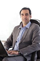 Portrait of a businessman with a laptop