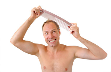 Smiling man hand holding comb on the head
