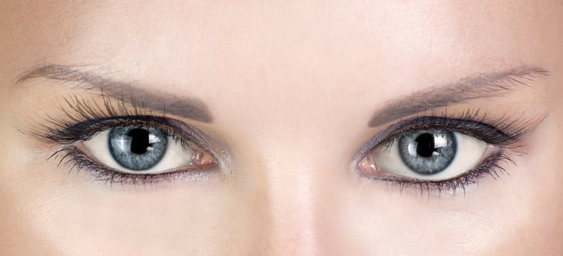 Woman blue eyes with beautiful long eyelashes