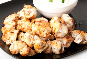 Delicious chicken skewers with cucumber cream sauce 