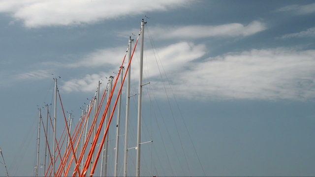 Yacht Masts swaying gently against a blue sky