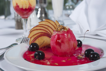 Baked apple dessert in cherry sauce