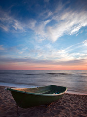 Sunset.Boat on coast.