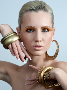 Vogue Style Portrait Of A Woman With Gold Makeup