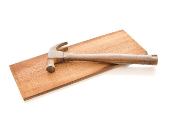 Old Vintage Wooden Hammer on a Plank of Wood