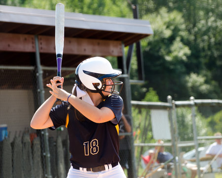 Young Teen Girl Playing Softball In Organized Game