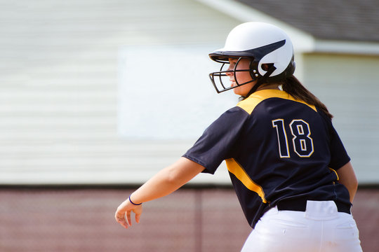 Young Teen Girl Playing Softball In Organized Game