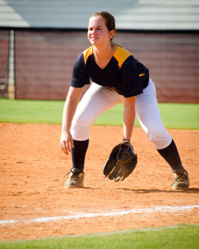 Young Teen Girl Playing Softball In Organized Game