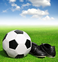 Fototapeta premium soccer ball and shoes in grass