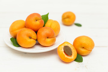 Apricots fruit in the bowl on background